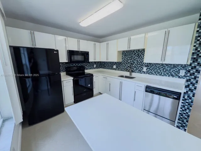 a kitchen with a sink stove and refrigerator