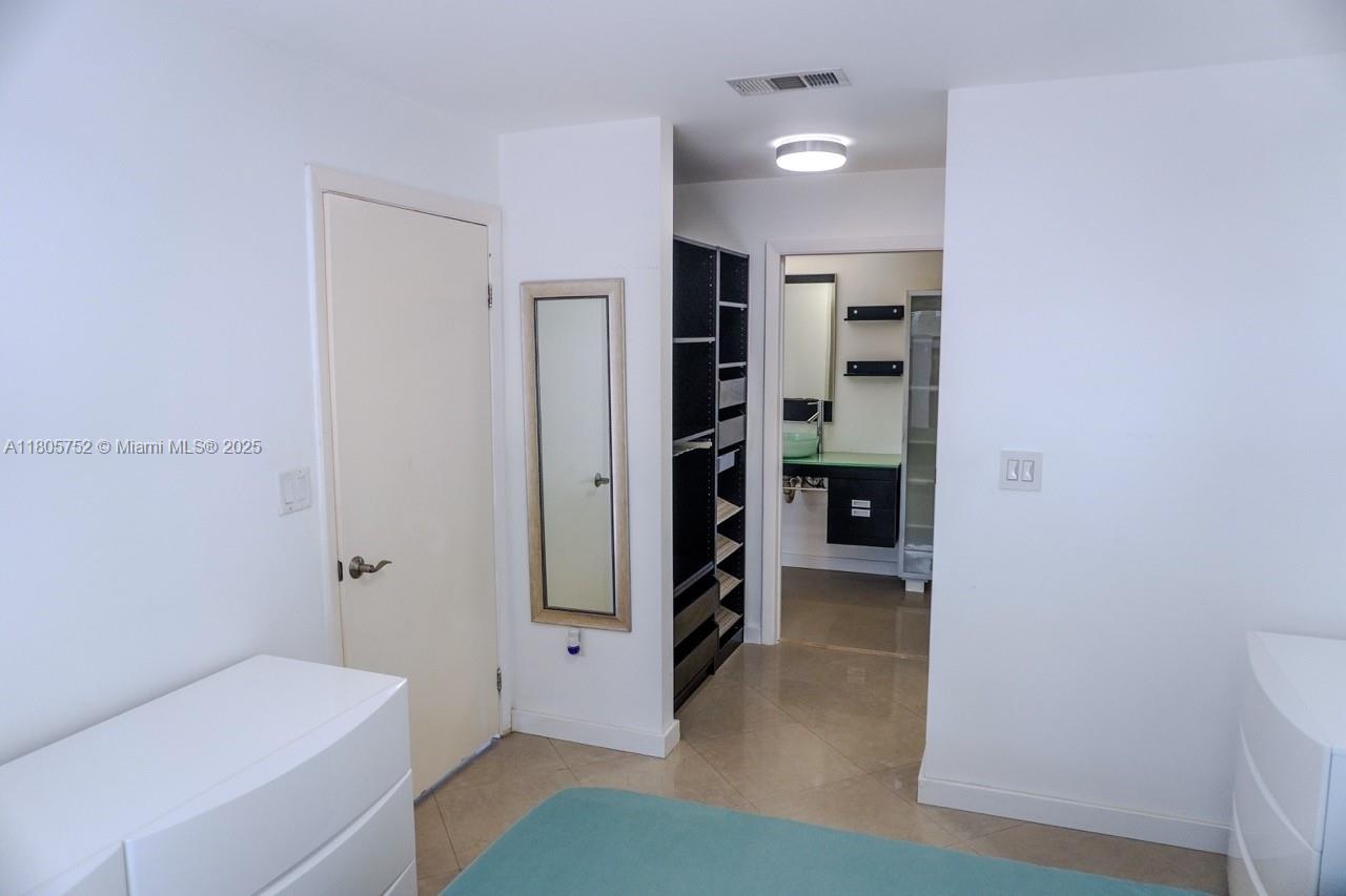 805 Northwest 108th Terrace, Unit 7L5 Pembroke Pines, FL 33026 - Photo 21 of 28 a view of a hallway with bathroom and a bathroom