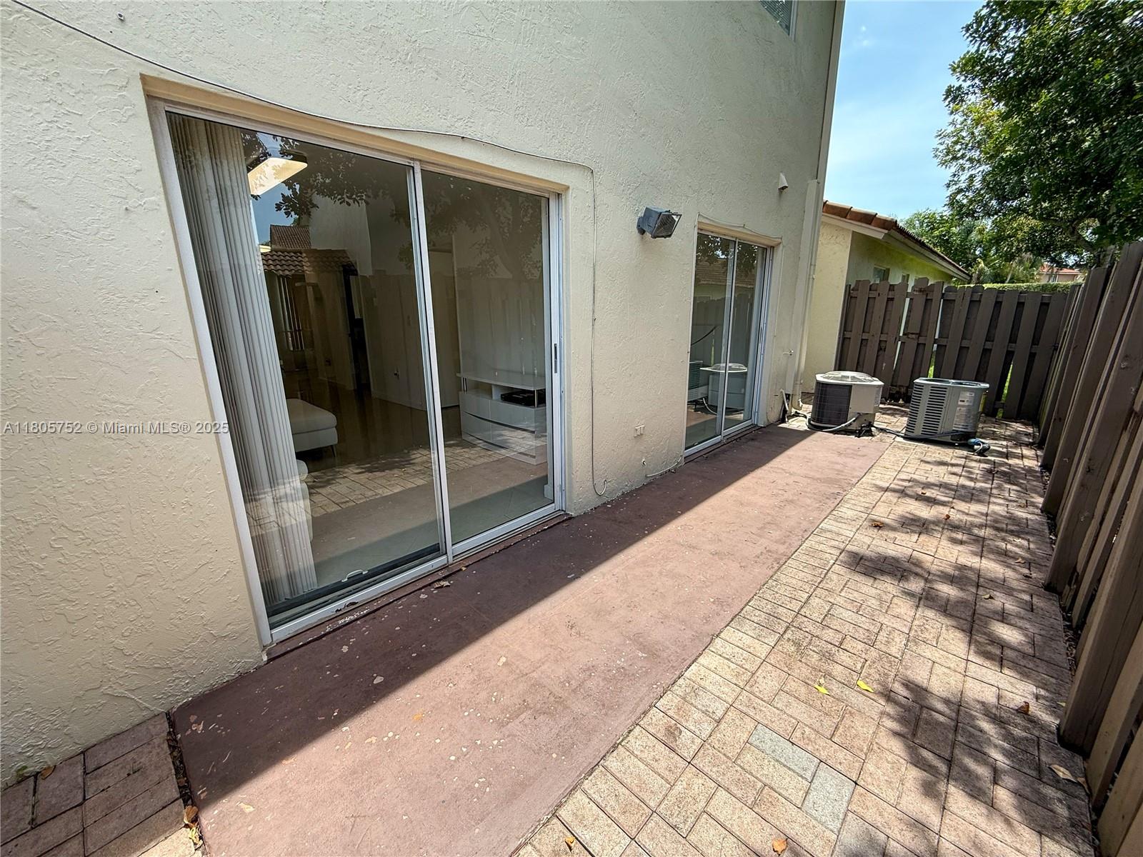 805 Northwest 108th Terrace, Unit 7L5 Pembroke Pines, FL 33026 - Photo 23 of 28 a outdoor space with sliding door and wooden floor