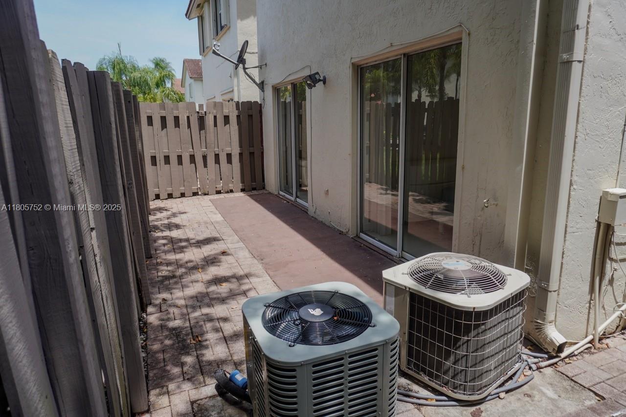 805 Northwest 108th Terrace, Unit 7L5 Pembroke Pines, FL 33026 - Photo 24 of 28 a room with a table and chairs