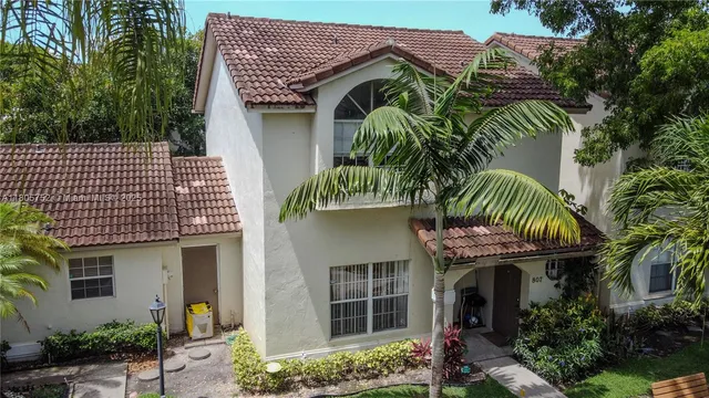 a front view of small house with a plant