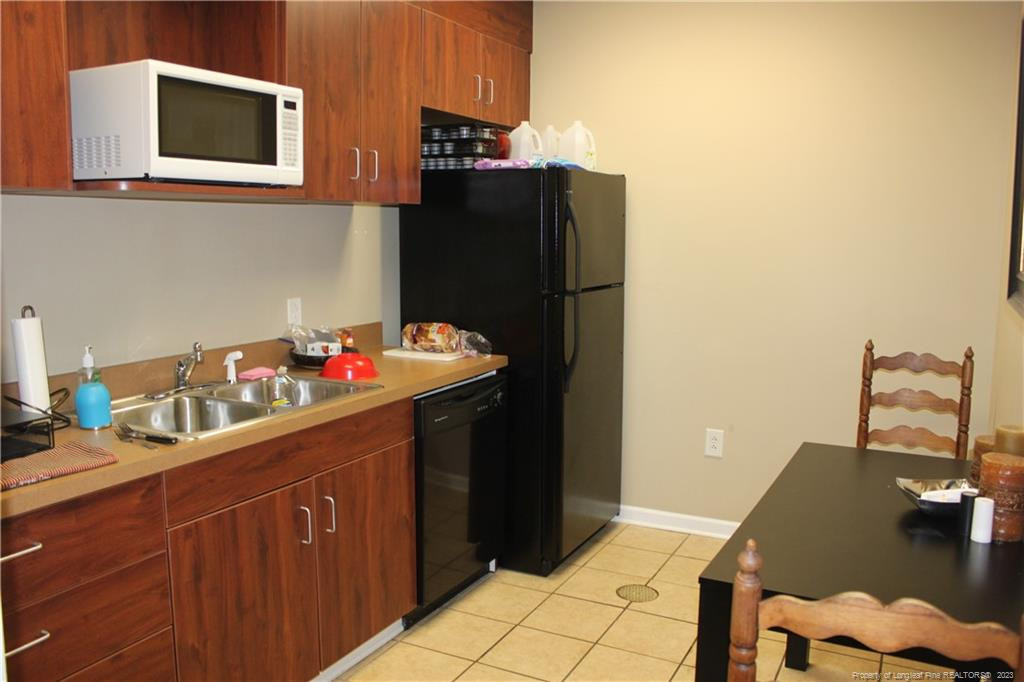 3709 Raeford Road Fayetteville, NC 28304 - Photo 14 of 44 a kitchen with a sink and cabinets