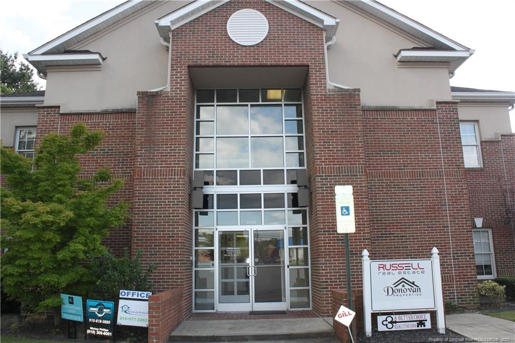 3709 Raeford Road Fayetteville, NC 28304 - Photo 2 of 44 a front view of a building with a garden