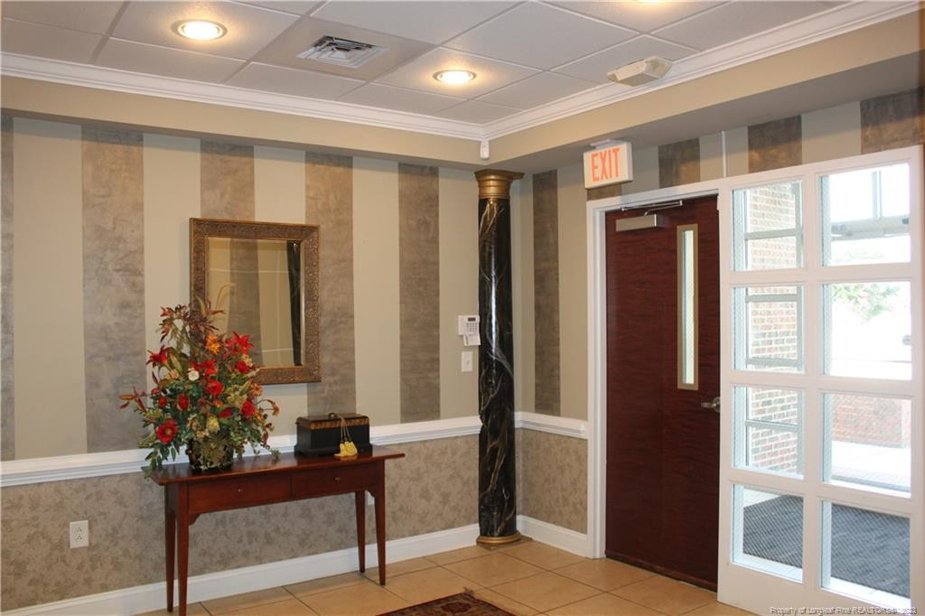 3709 Raeford Road Fayetteville, NC 28304 - Photo 7 of 44 a view of a hallway with a potted plant and couches