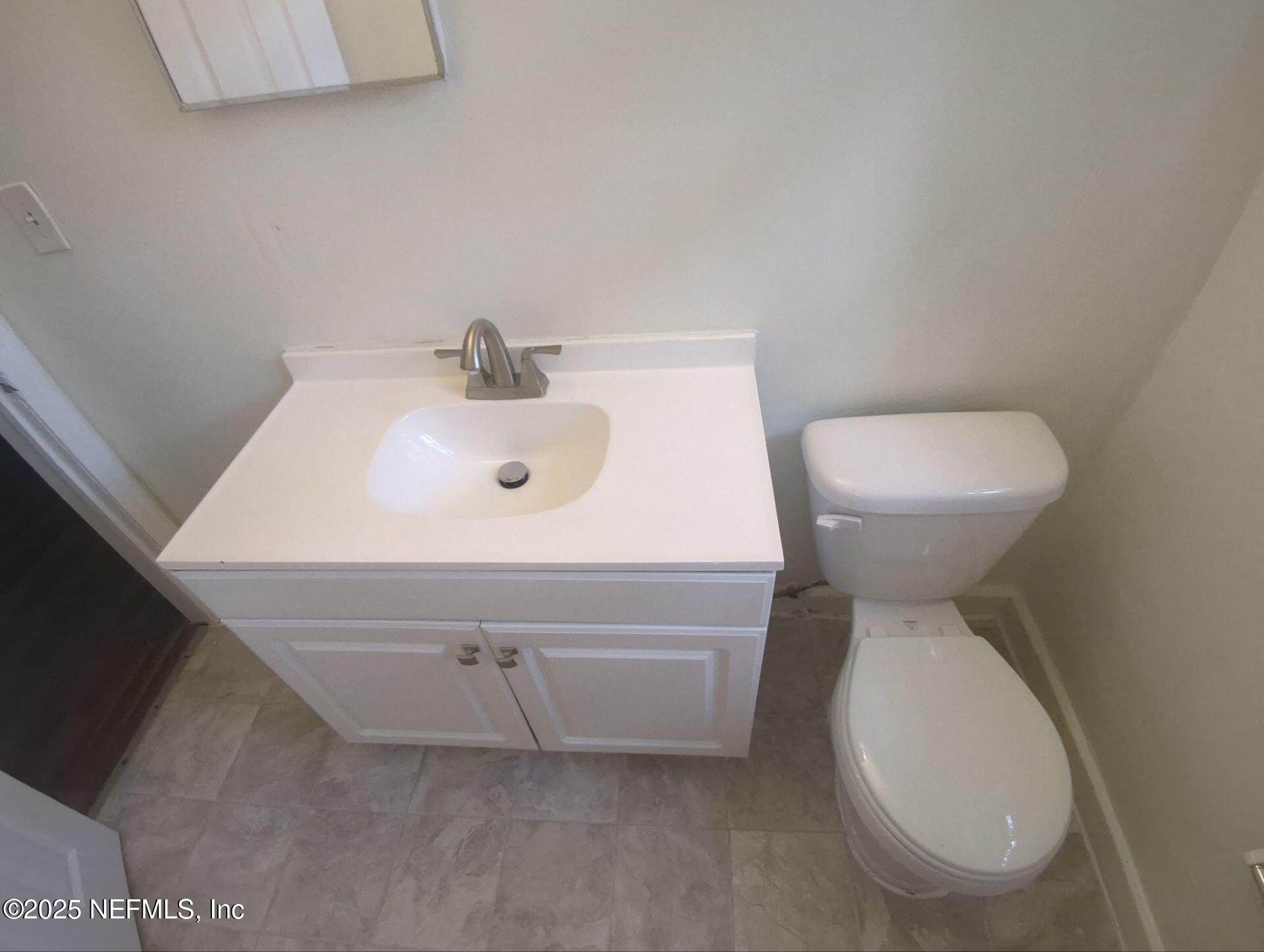 3136 Post Street Jacksonville, FL 32205 - Photo 14 of 16 a bathroom with a sink a toilet and mirror