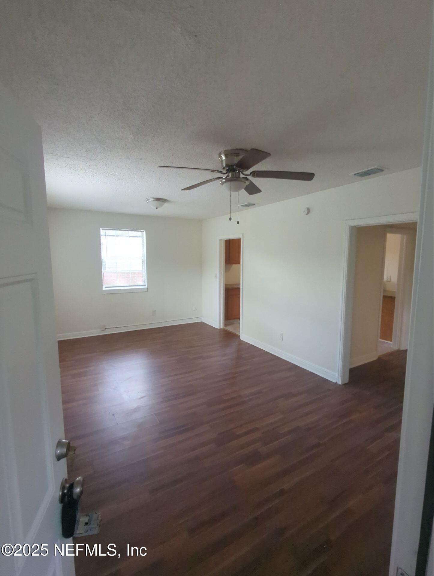 3136 Post Street Jacksonville, FL 32205 - Photo 2 of 16 an empty room with wooden floor and windows
