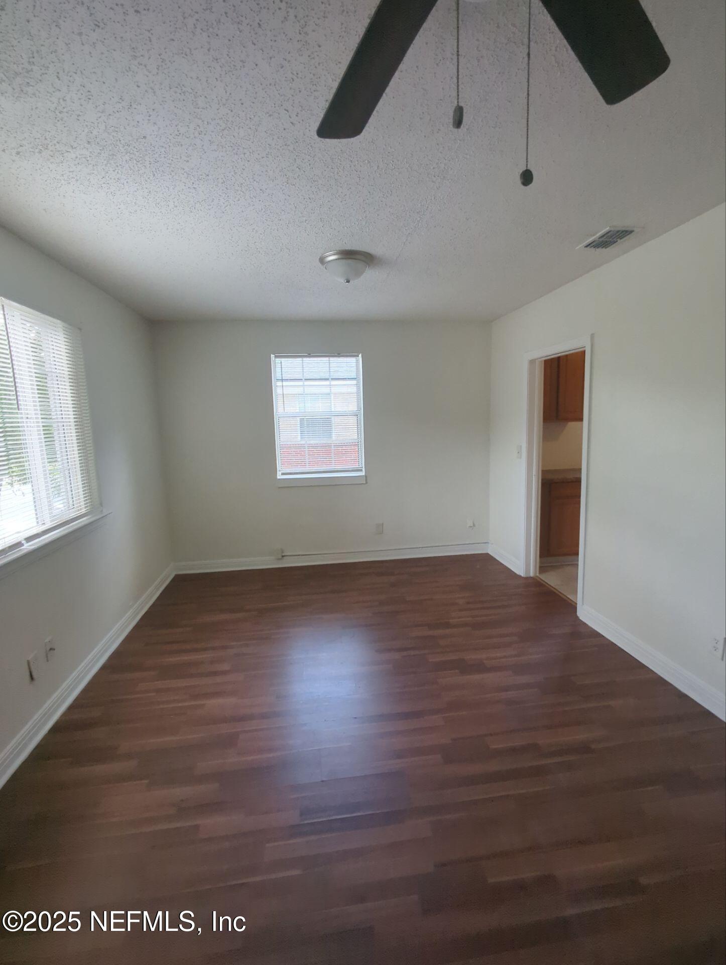 3136 Post Street Jacksonville, FL 32205 - Photo 3 of 16 an empty room with wooden floor and windows
