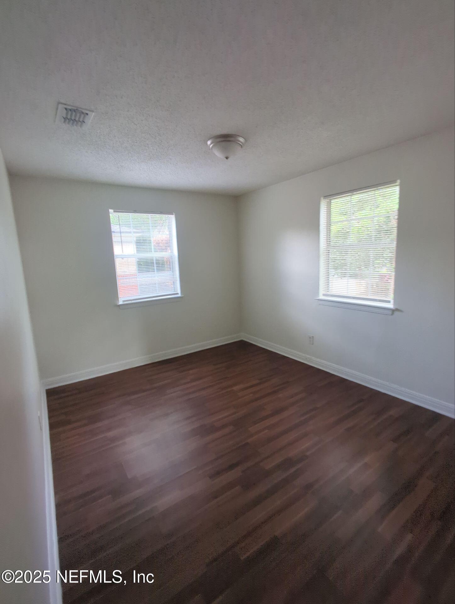 3136 Post Street Jacksonville, FL 32205 - Photo 4 of 16 an empty room with wooden floor and windows