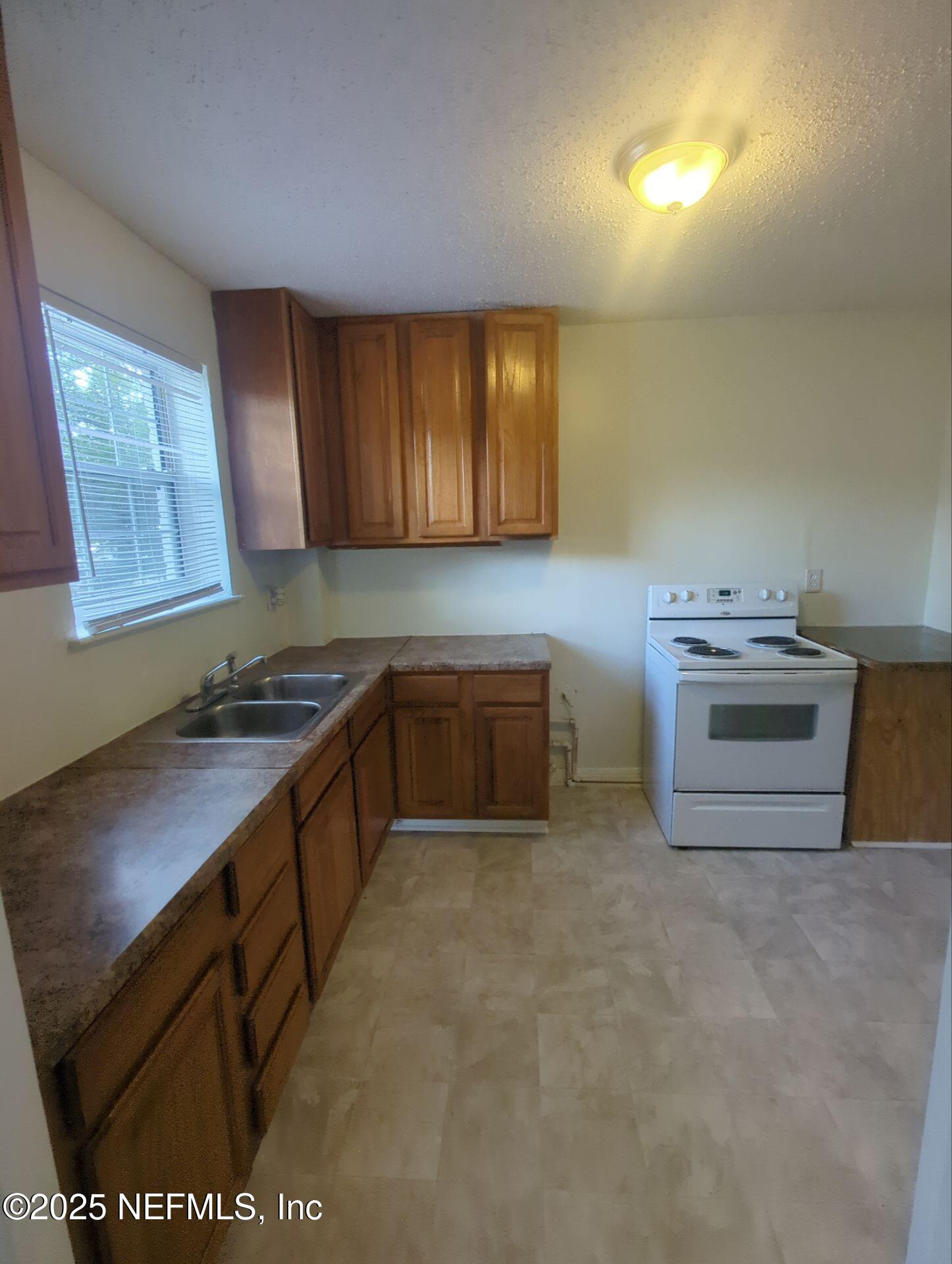 3136 Post Street Jacksonville, FL 32205 - Photo 6 of 16 a kitchen with a stove and a sink