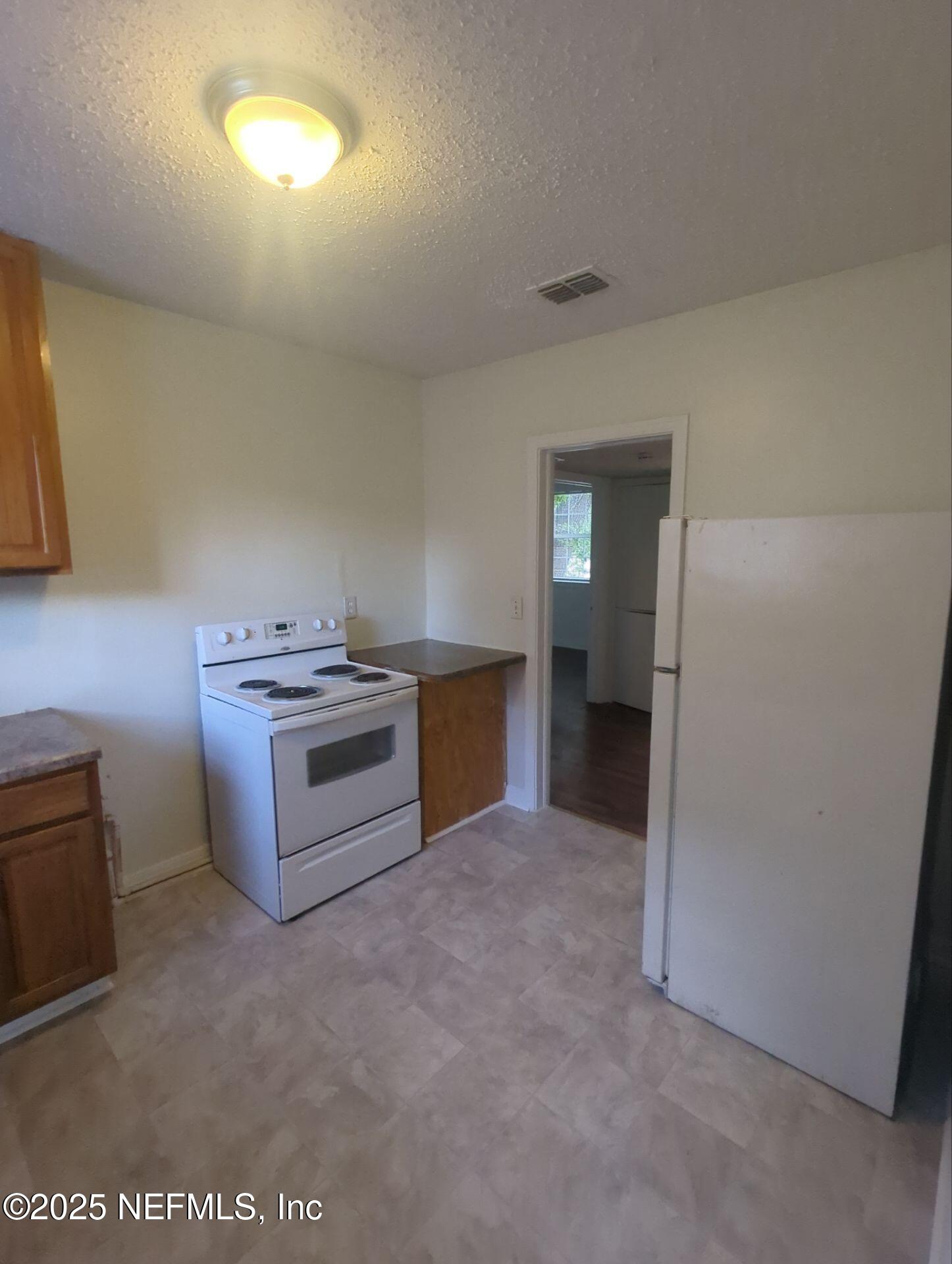 3136 Post Street Jacksonville, FL 32205 - Photo 7 of 16 a kitchen with a stove and a refrigerator