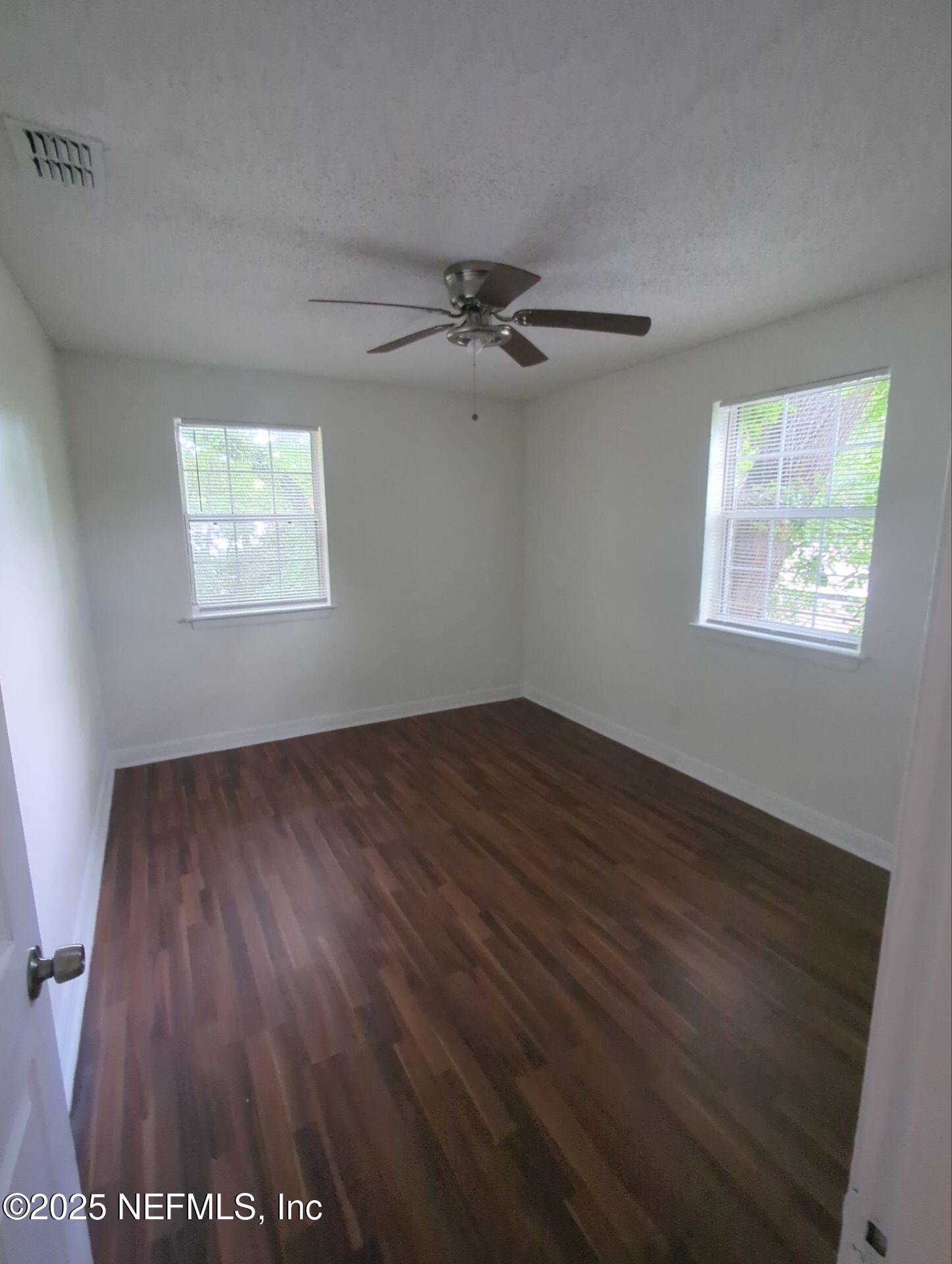 3136 Post Street Jacksonville, FL 32205 - Photo 10 of 16 wooden floor in an empty room with a window