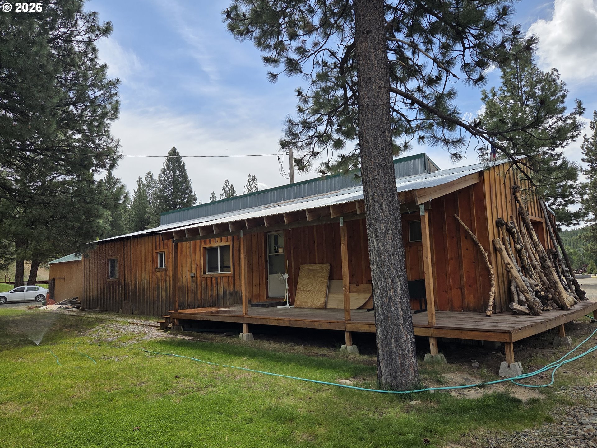 602 Mill Street Sumpter, OR 97877 - Photo 11 of 25 a view of backyard with wooden fence and large trees