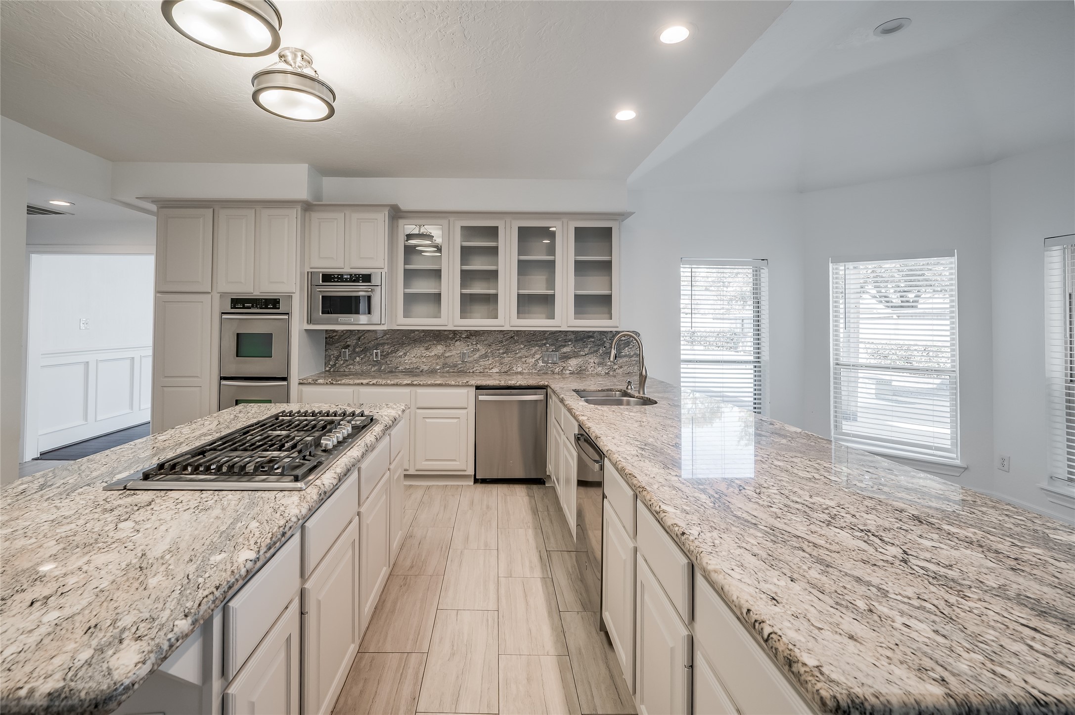 5527 Fragrant Cloud Court Houston, TX 77041 - Photo 11 of 38 a kitchen with granite countertop a stove a sink and a refrigerator