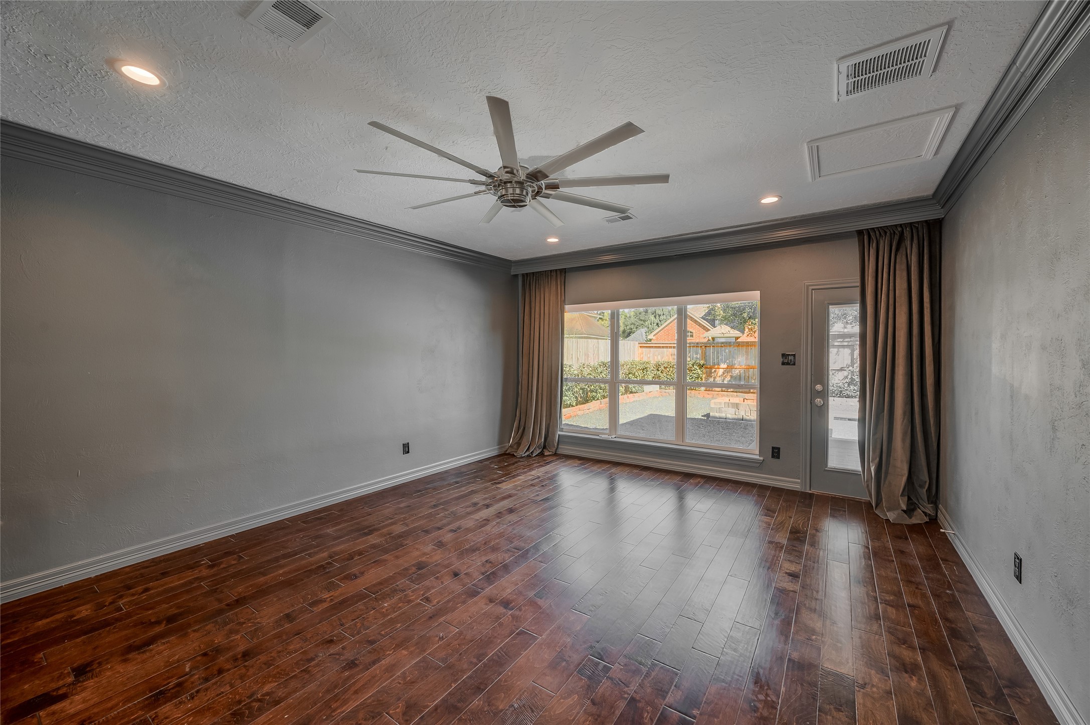 5527 Fragrant Cloud Court Houston, TX 77041 - Photo 16 of 38 an empty room with wooden floor and windows
