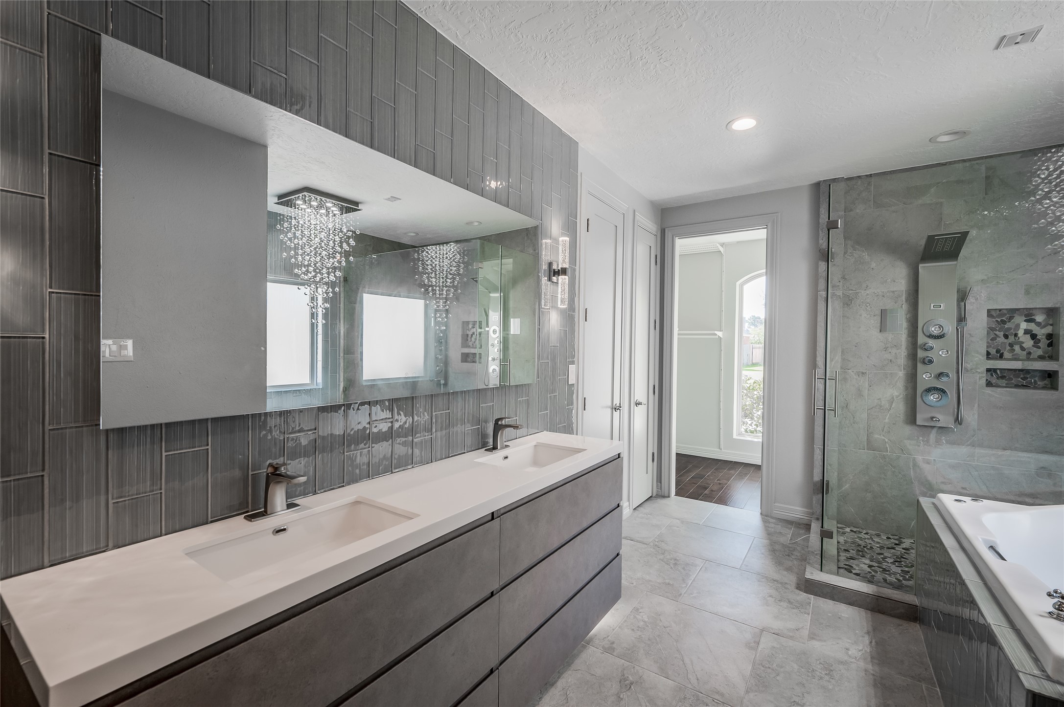 5527 Fragrant Cloud Court Houston, TX 77041 - Photo 17 of 38 a bathroom with a double vanity sink a mirror and a shower