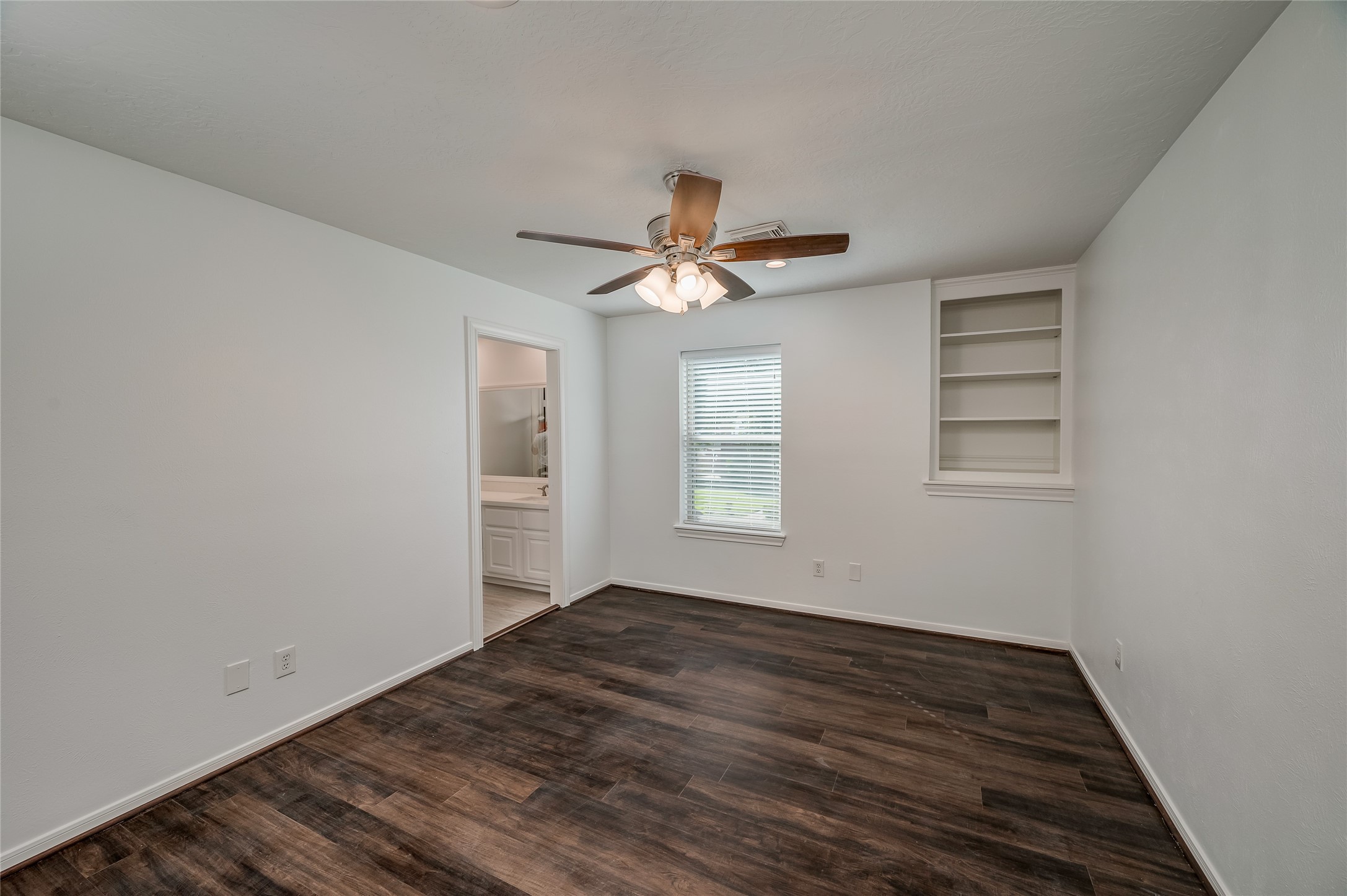 5527 Fragrant Cloud Court Houston, TX 77041 - Photo 23 of 38 a view of a room with wooden floor and a ceiling fan