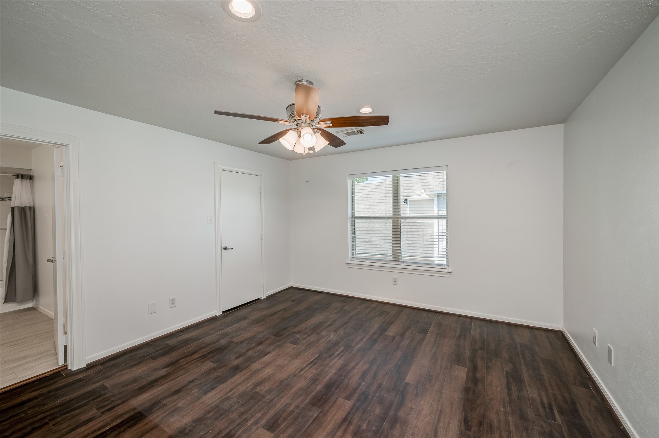 5527 Fragrant Cloud Court Houston, TX 77041 - Photo 27 of 38 wooden floor in an empty room with a window