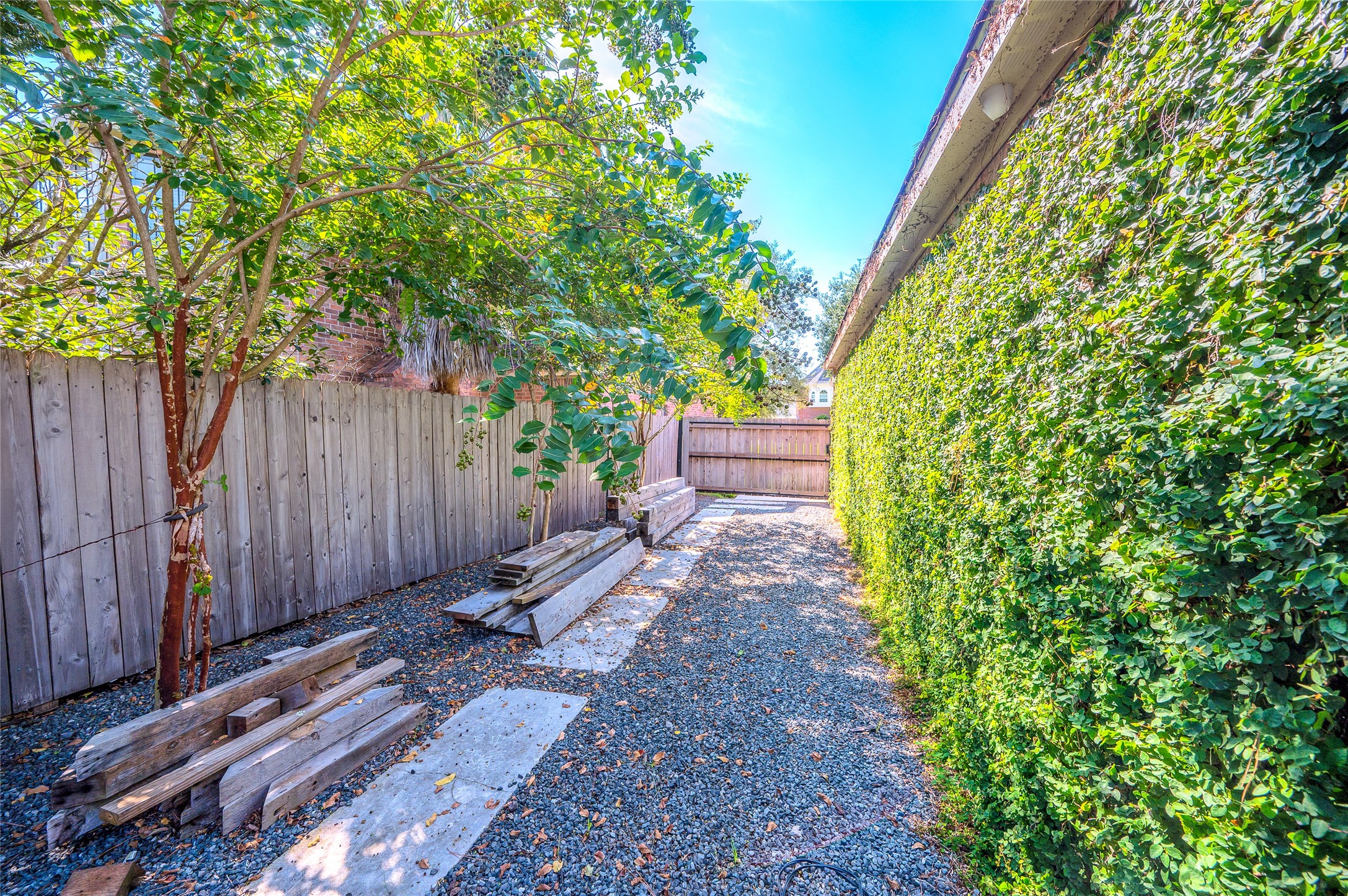 5527 Fragrant Cloud Court Houston, TX 77041 - Photo 35 of 38 a view of a backyard with potted plants and large trees