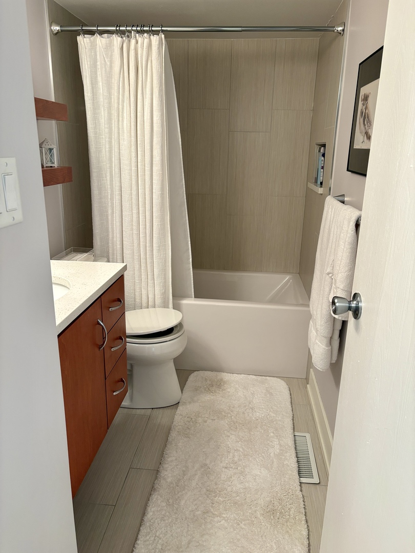 5802 Wolf Road, Unit 1 Western Springs, IL 60558 - Photo 14 of 16 a bathroom with a sink toilet and shower