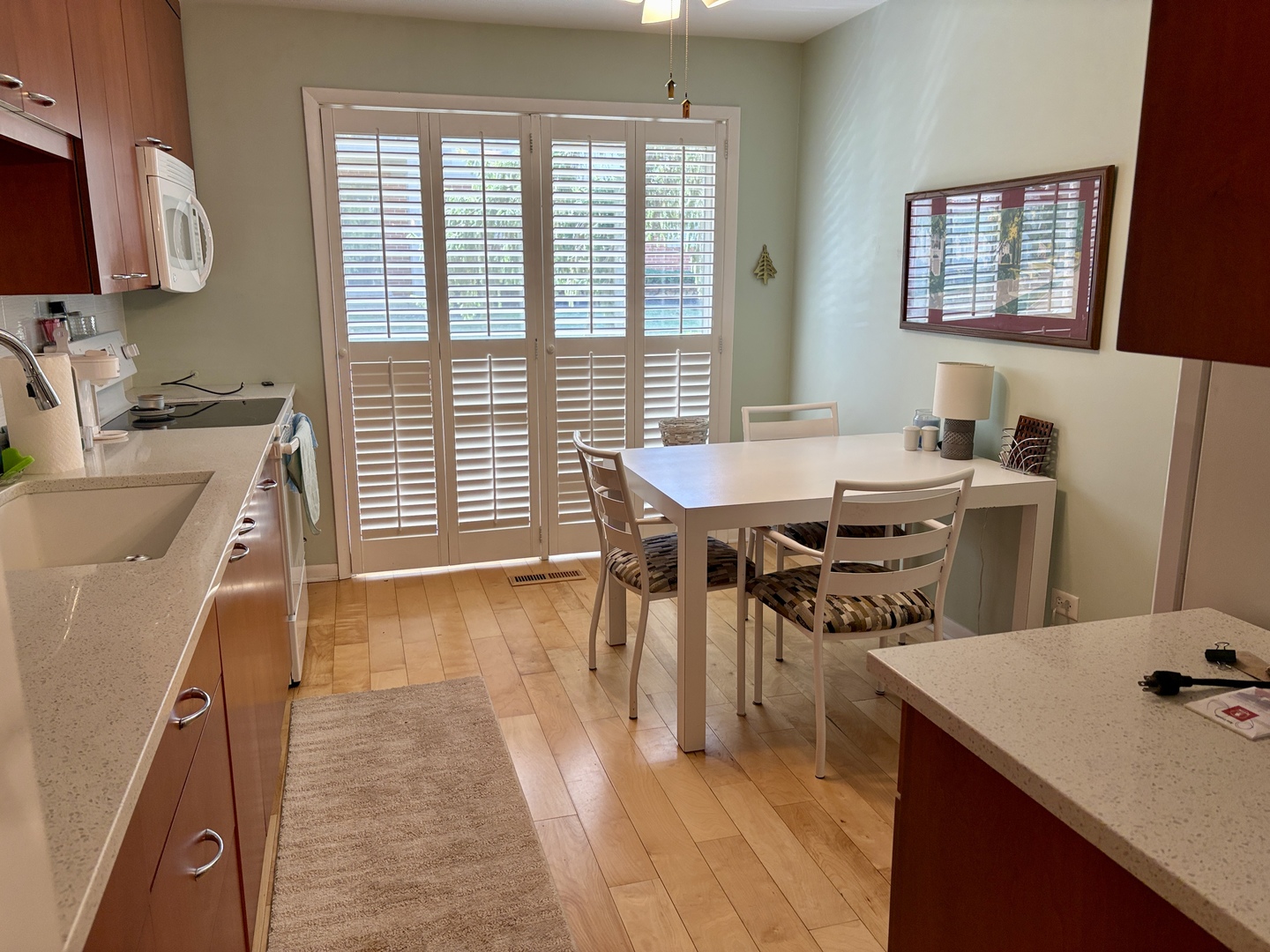 5802 Wolf Road, Unit 1 Western Springs, IL 60558 - Photo 6 of 16 a dining hall with stainless steel appliances granite countertop a sink dishwasher and a stove with wooden floor