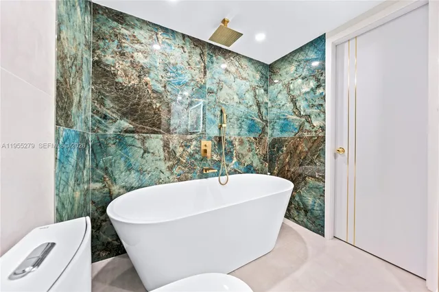 a white bath tub sitting in a bathroom