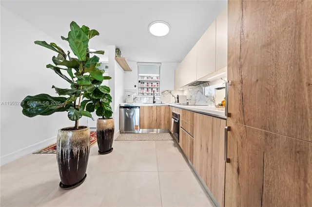 a white bath tub sitting in a bathroom next to a window