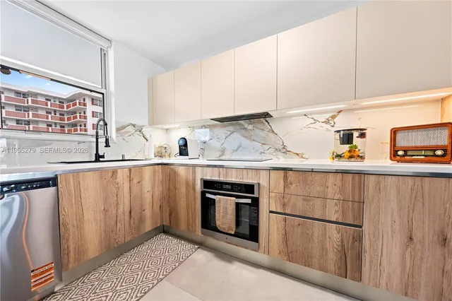 a kitchen with appliances a sink and cabinets