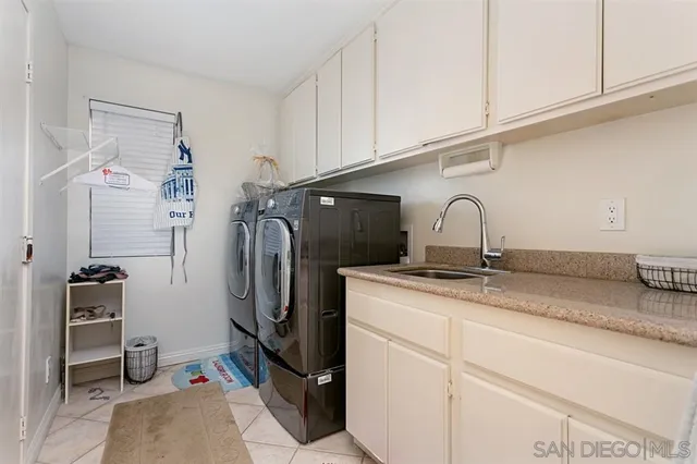 a kitchen with stainless steel appliances granite countertop a sink and a refrigerator
