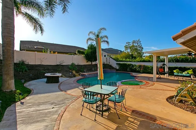 a view of a patio with a table and chairs