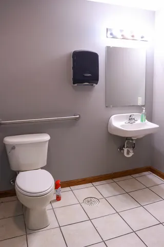 a bathroom with a sink toilet and a mirror