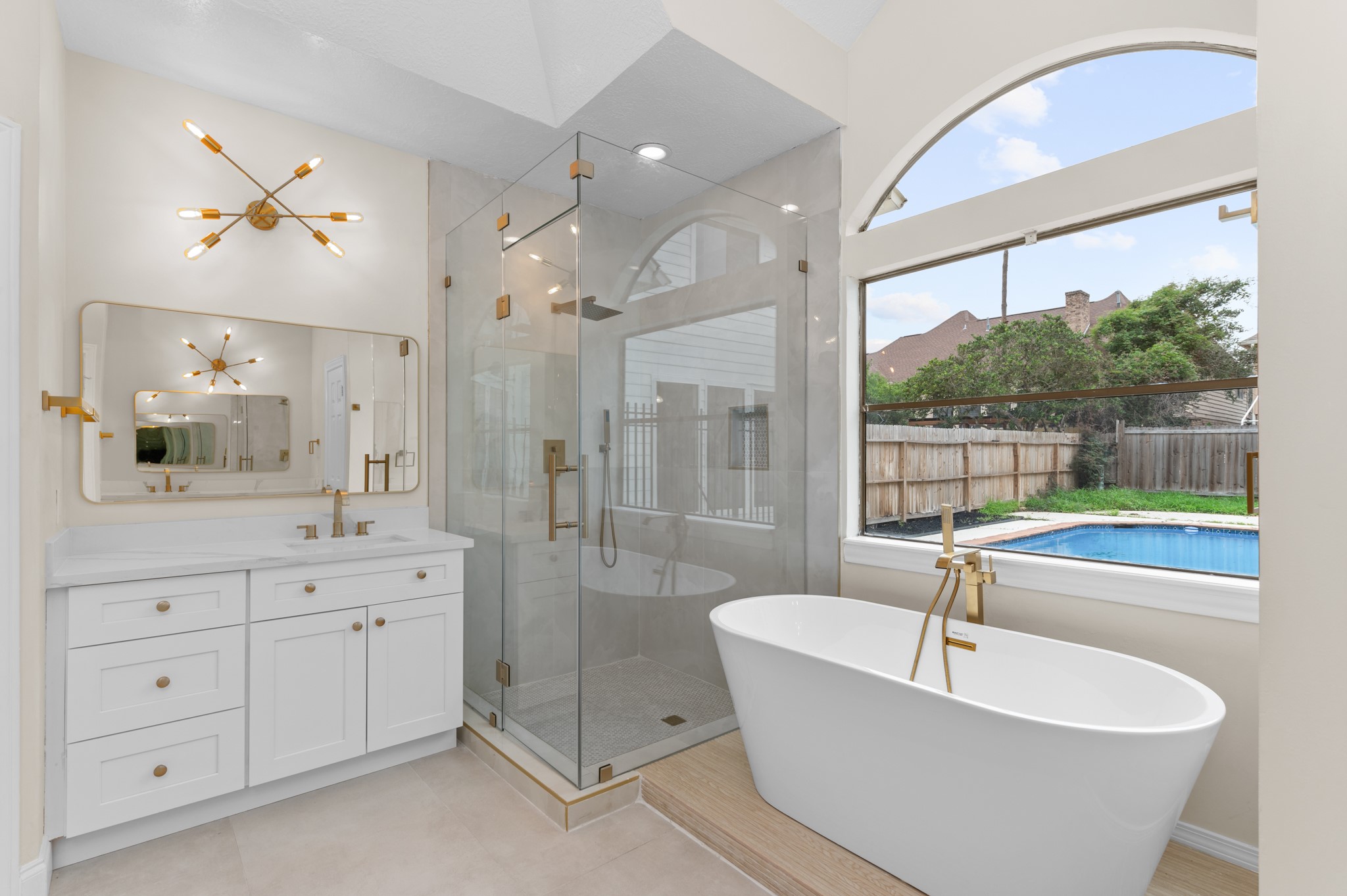 17402 Wilton Park Court Spring, TX 77379 - Photo 16 of 50 a spacious bathroom with a tub sink a mirror a shower and vanity