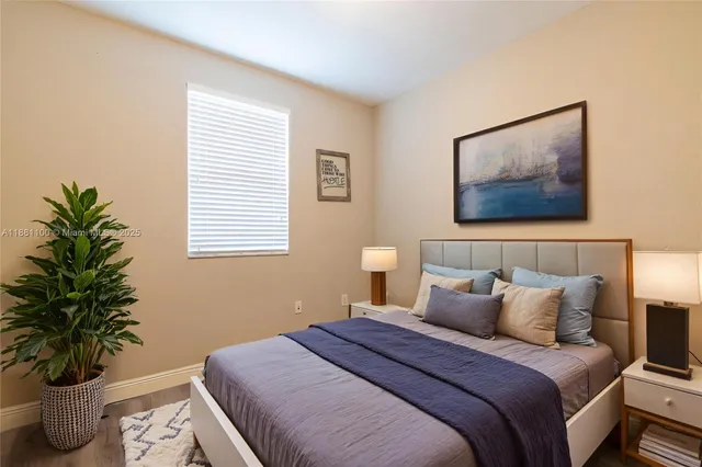 a bedroom with a bed and a potted plant