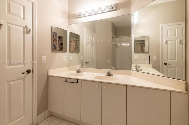 a bathroom with a double vanity sink and mirror