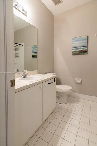 a bathroom with a sink toilet and mirror