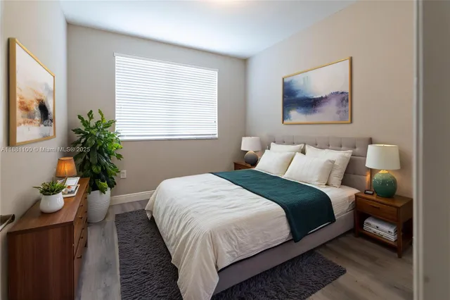 a bedroom with bed and a potted plant