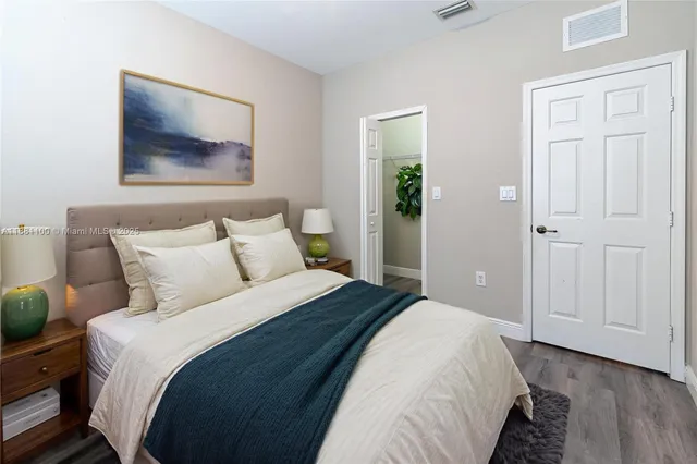 a bedroom with bed and a window