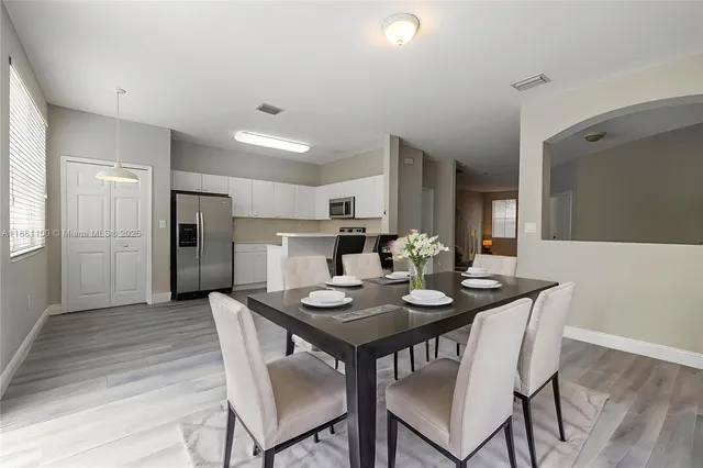 a dining room with furniture and wooden floor