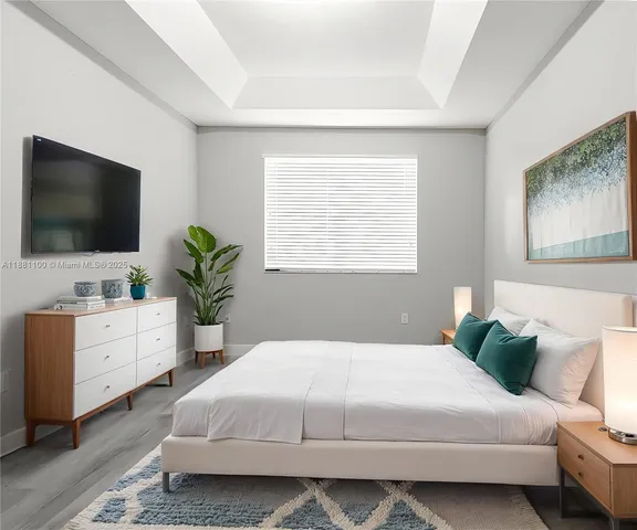 a bedroom with a large bed and a flat screen tv