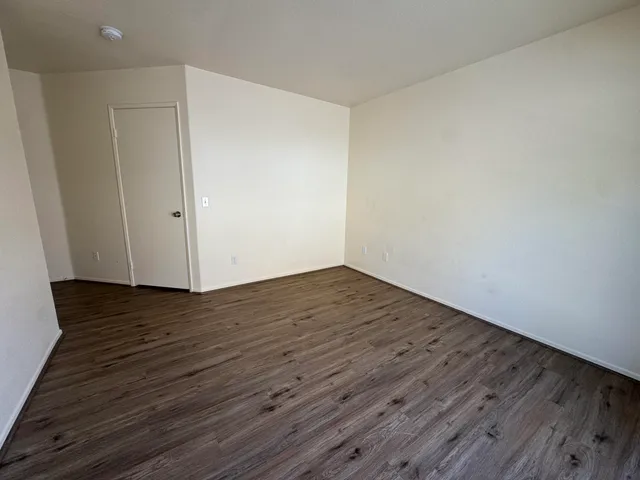 a view of a room with wooden floor