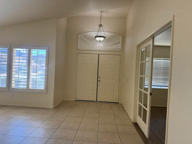 an empty room with closet and windows