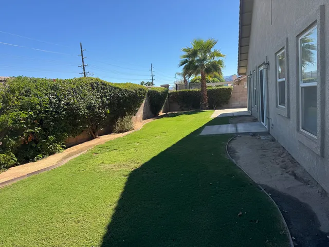 a view of a house with a backyard