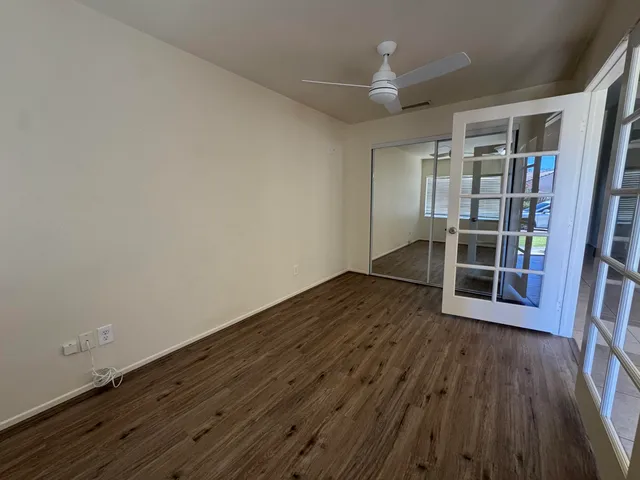 wooden floor in an empty room with a window