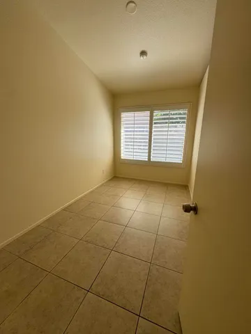 an empty room with a empty space and windows