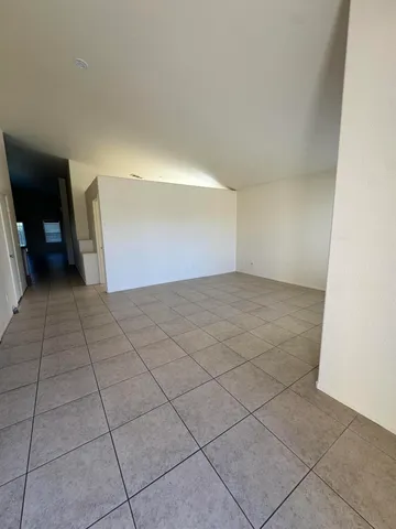 a view of an empty room and hallway