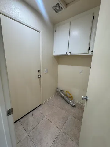 a view of a storage and utility room with closet