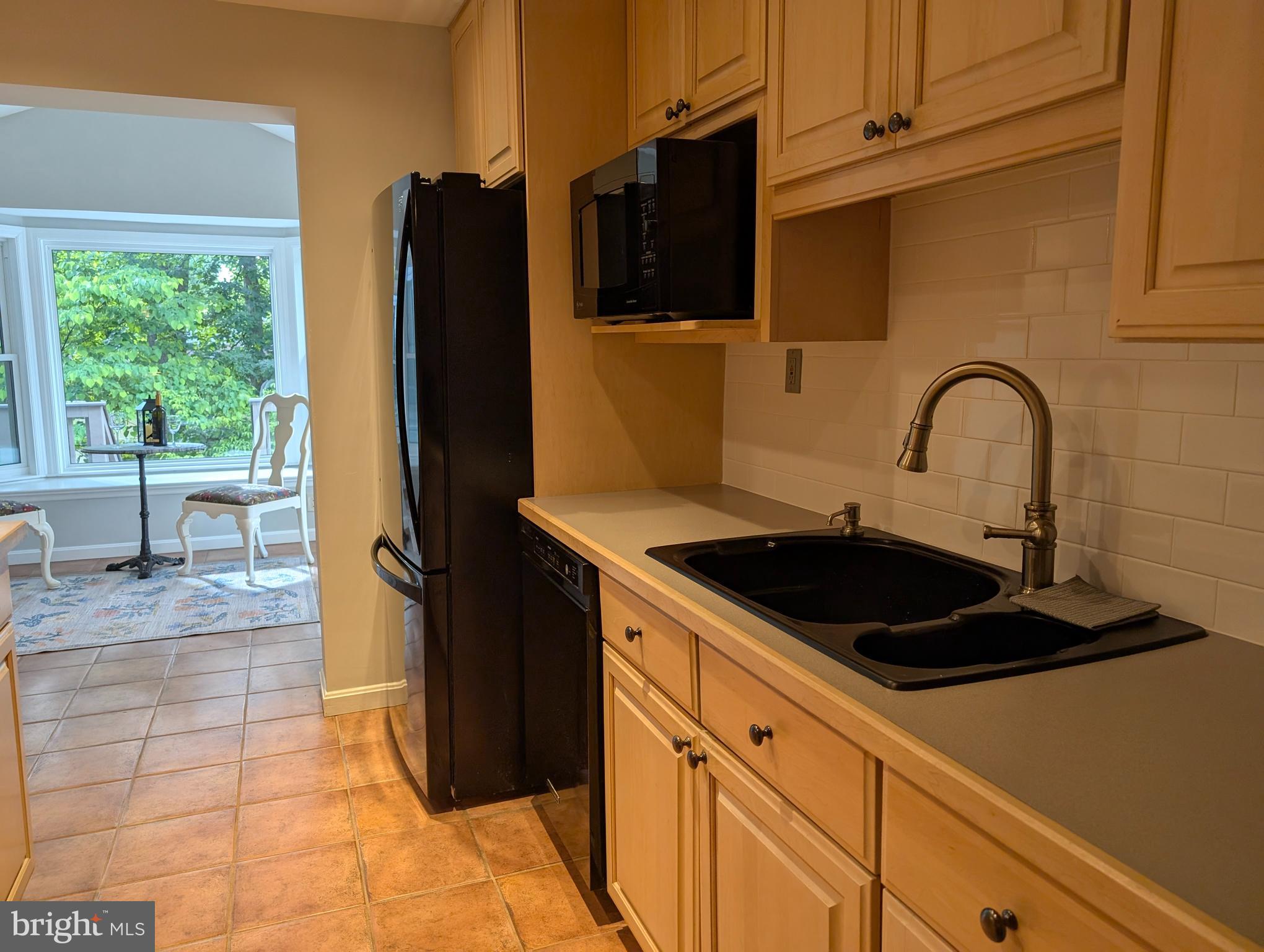 9510 Clement Road Silver Spring, MD 20910 - Photo 11 of 80 a kitchen with a sink a refrigerator and a stove