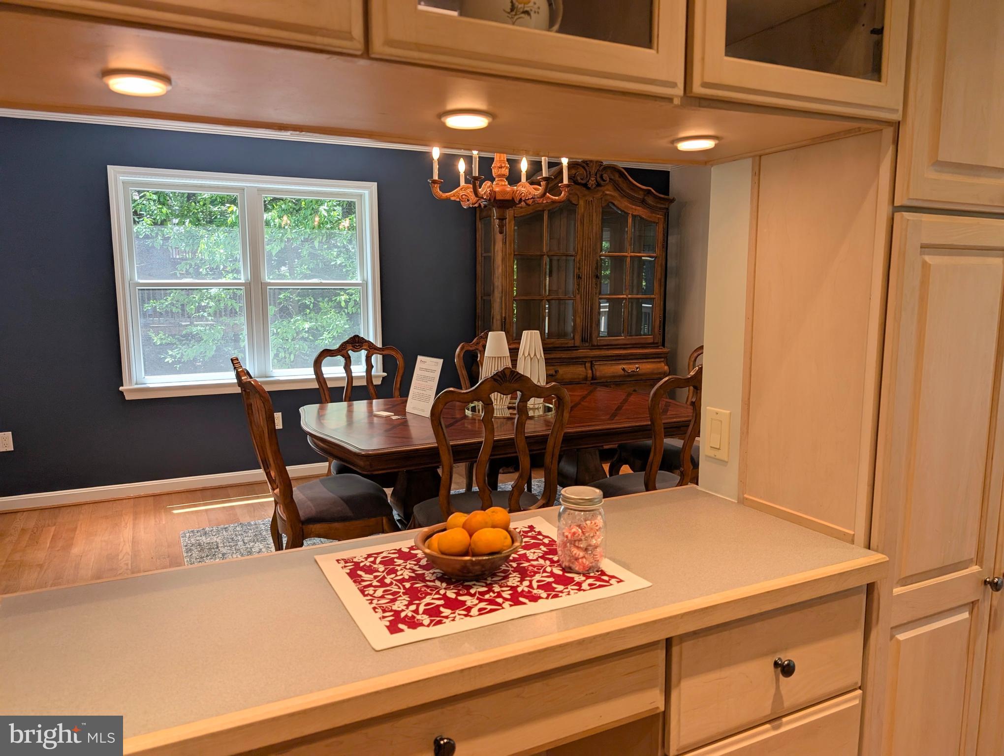9510 Clement Road Silver Spring, MD 20910 - Photo 12 of 80 a view of a dining room with furniture chandelier and a window