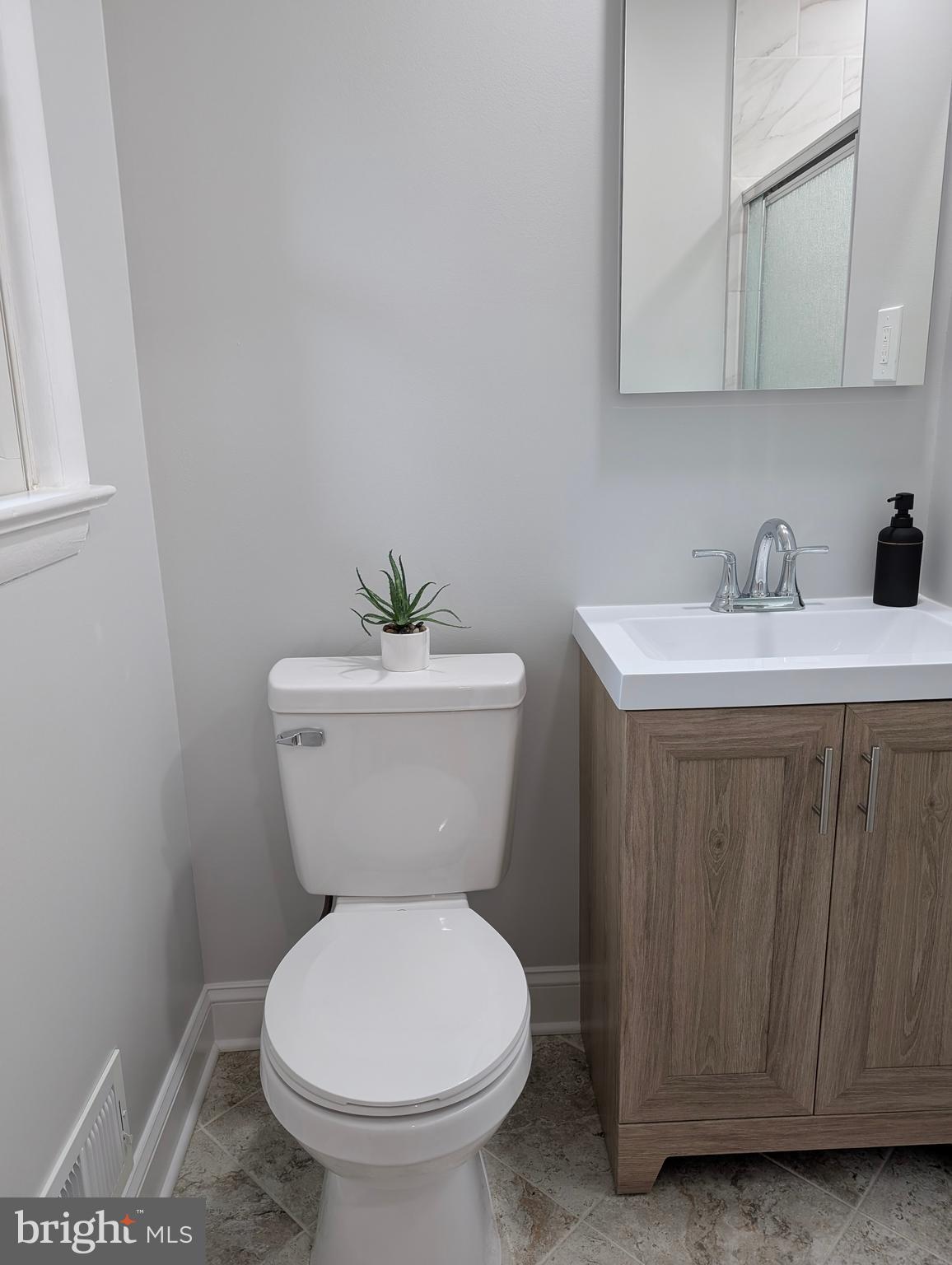 9510 Clement Road Silver Spring, MD 20910 - Photo 23 of 80 a bathroom with a toilet sink and mirror
