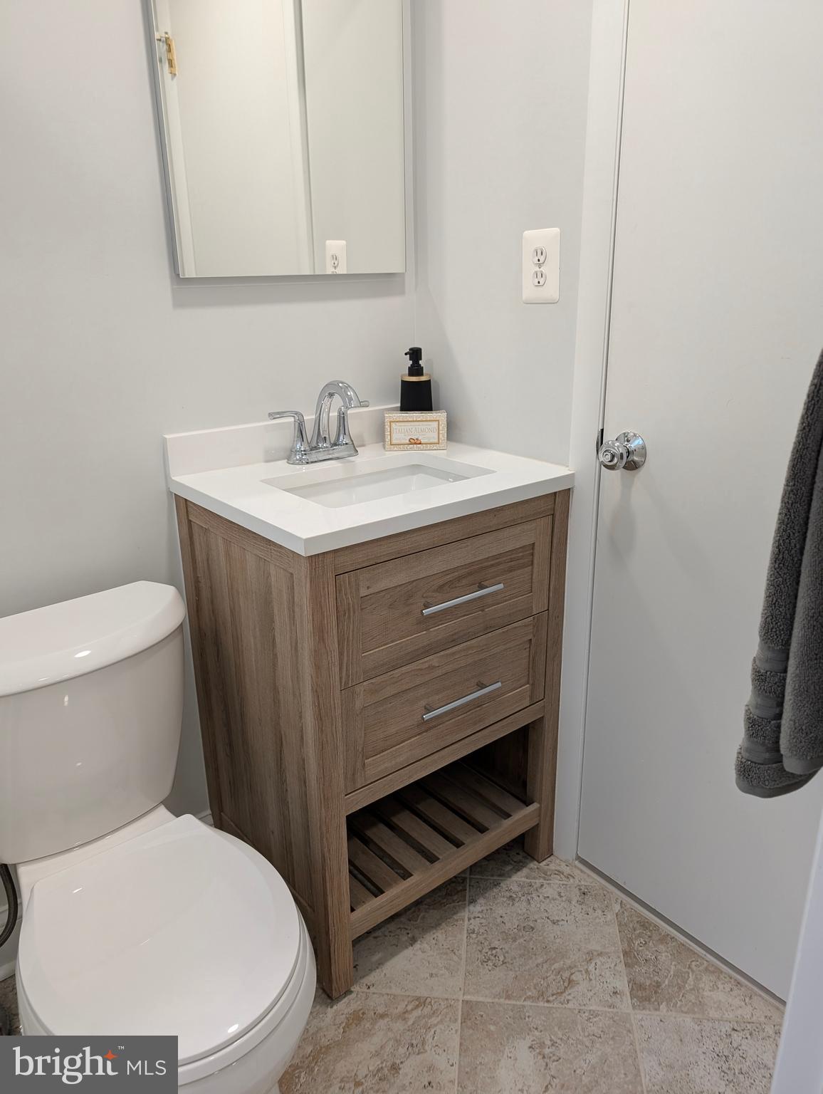 9510 Clement Road Silver Spring, MD 20910 - Photo 32 of 80 a bathroom with a sink a toilet and a mirror