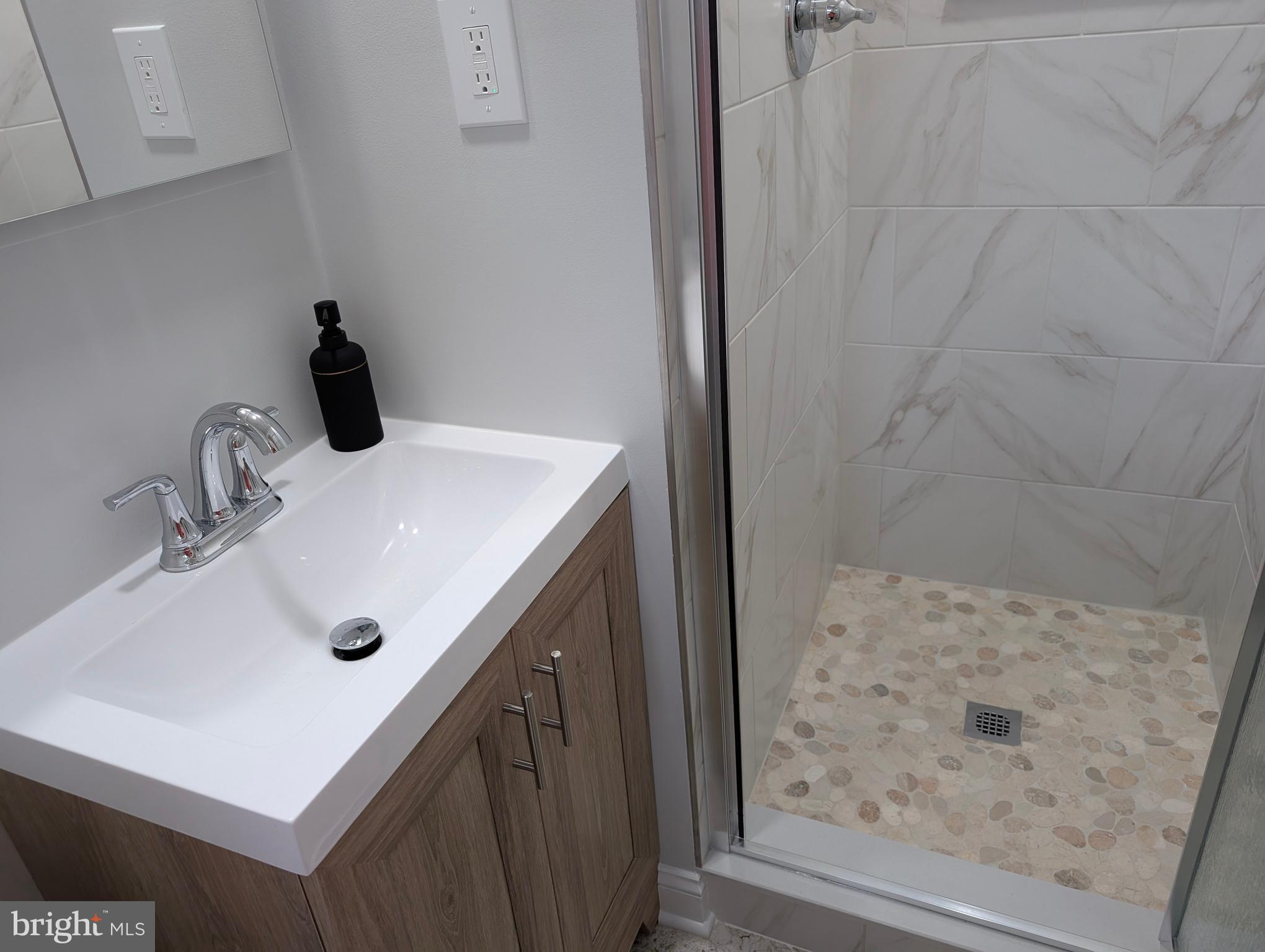 9510 Clement Road Silver Spring, MD 20910 - Photo 38 of 80 a bathroom with a sink and a mirror